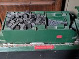 a green box filled with coal sitting on a table