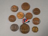 a lot of coins and a pin on a table