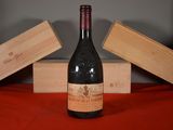 a bottle of wine sitting on a table next to two wooden boxes