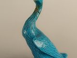 two figurines of birds sitting on top of each other