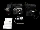 three cameras and a bag on a black background