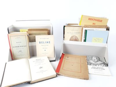 several books are sitting in a box on a white surface