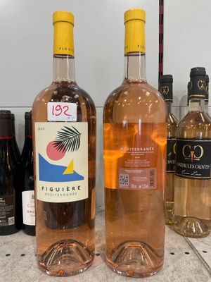 several bottles of wine are lined up on a counter