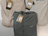 three pairs of men ' s nike pants and a pair of men ' s nike pants