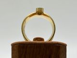 an image of a gold ring sitting on top of a wooden box
