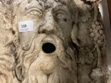 a stone sculpture of a man ' s face on display