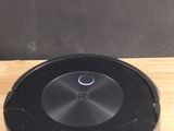 a wooden table with a black disc on it