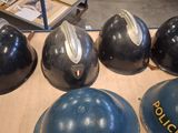 several helmets are lined up on a table in a room