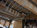 a picture of a room with a wooden ceiling and a window