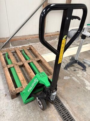 a picture of a pallet with a hand truck attached to it