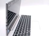 a white laptop with a black keyboard on a white surface