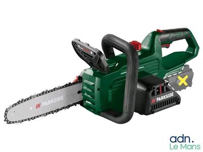 a green and black chainsaw on a white background