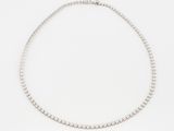 a white gold tennis necklace with diamonds on a white background