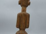 a wooden sculpture of a man with a hat on his head