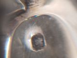 a close up view of a metal object with a hole in it