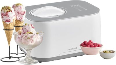 an ice cream maker with two scoops of ice cream and a bowl of raspberries