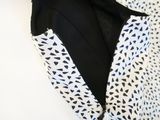 a close up of a black and white dress with a black and white pattern