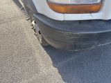 a close up of a white truck with a flat tire