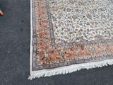 a rug on the ground next to a chair