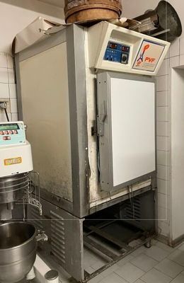a machine that is sitting in a kitchen next to a bowl