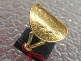 a gold ring with a red string around it