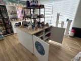 a room with a counter, shelves, and other items in it