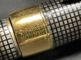 a close up of a fountain pen with a gold band on it