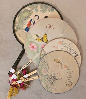Trois éventails chinois sont posés les uns à côté des autres sur une table.