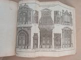 an open book with a drawing of a building on it