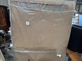 a picture of a refrigerator in a warehouse with a cover over it