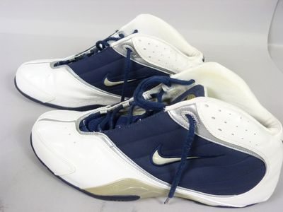 pair of white and blue sneakers with blue laces on a white surface