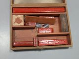 a wooden box with several different types of tools in it