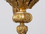 an image of a gold clock hanging from the side of a wall