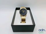 a close up of a watch in a box on a white surface
