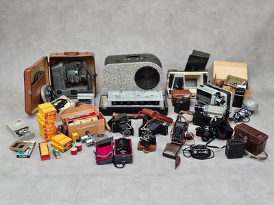 beaucoup de vieux appareils photo et d'autres objets sur la table
