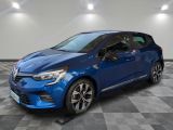 the blue car is parked on a checkered floor in a garage