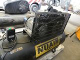a black air compressor sitting on a pallet in a warehouse