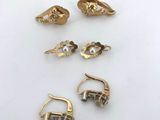 five pairs of gold earrings and a pair of earrings