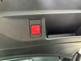 a close up of a red button on a car ' s dashboard
