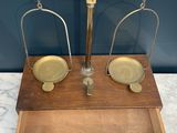 an antique scale with a wooden box on top of it