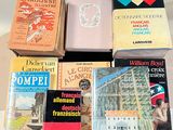 several books are stacked on top of each other on a table