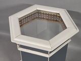 a white and gray octagonal table with a glass top
