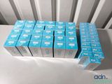 many boxes of toothpaste sitting on a table