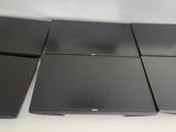 four laptops sitting on a table in a room