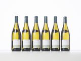 six bottles of white wine lined up in a row