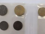 three different types of coins in plastic bags on a white surface