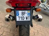 a red motorcycle parked on the side of the road