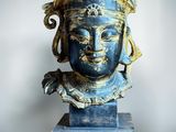an image of a statue of a woman ' s head on a marble base
