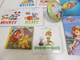 many children ' s books and toys on the table