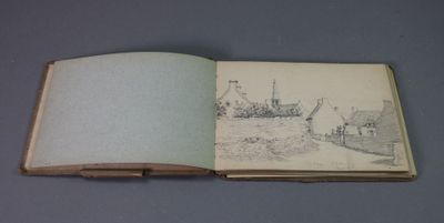 un livre ouvert sur lequel est dessiné un village